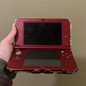 - Red Nintendo 3DS with Pokemon protector, super mario case, and 7 games